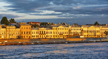 Fototapeta na wymiar The houses on the waterfront of St. Petersburg during sunset