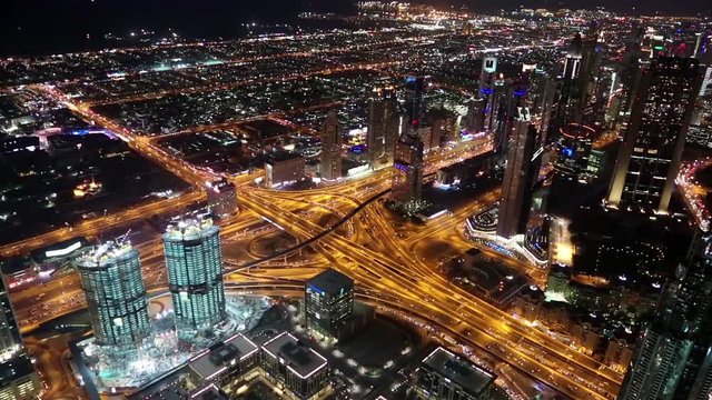 View on the night Sheikh Zayed road from Burj Khalifa skyscraper in Dubai, UAE.  Burj Khalifa - megatall skyscraper and currently the tallest structure in the world, 829,8 m or 2,722 ft