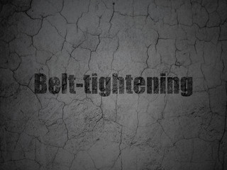 Finance concept: Belt-tightening on grunge wall background
