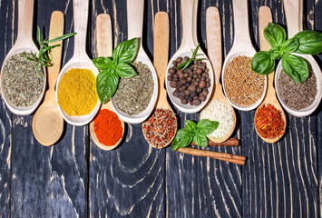 Colorful aromatic spices and herbs on an old  wooden backgrownd