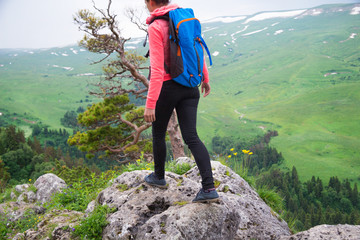 Young Woman Traveler with Backpack hiking in Mountains with beau