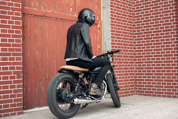 Biker and vintage custom motorcycle © Kaponia Aliaksei