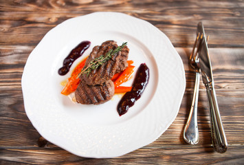 Delicious grilled meat with vegetable with rosemary on dark wood