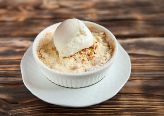 Tasty dessert with an ice cream ball on a wooden background