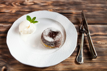Warm cut chocolate fondant with ice cream and cinnamon. Tasty fr