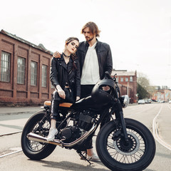 Couple in love and vintage custom motorcycle