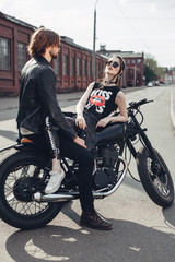 Fototapeta na wymiar Couple in love and vintage custom motorcycle