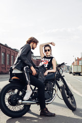 Fototapeta na wymiar young couple sitting on vintage motorcycle