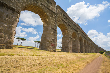 Fototapeta na wymiar Ruins of the Aqua Claudia in Parco degli Acquedotti in Rome, Italy 