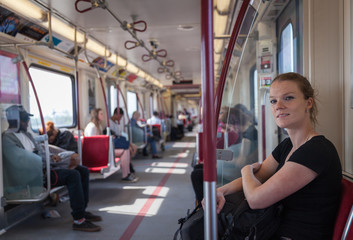 Woman travels overground metro in the afternoon in Canada