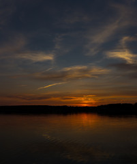 Obraz premium Majestic red sunset and its reflection in river