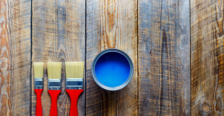 concept preparation for painting with can of blue paint
