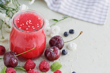 Delicious raspberry and sweet cherry smoothie or milk shake with