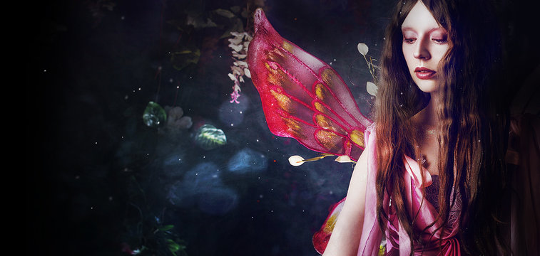 Young beautiful woman in the image of fairies, magic dark forest