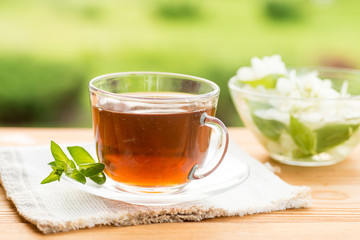 Herbal tea in a cup with  and honey, summer garden