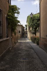 Fototapeta premium Old alley in the city centre of Ferrara Italy