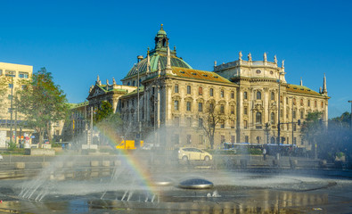 Fototapeta premium View of langericht court in german city munich hidden behind magnificent fountain.