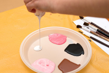 pouring paint on the palette