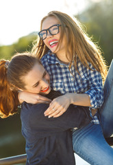 Two playful young women having fun outdoors