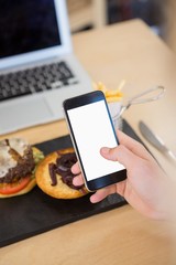 Man taking photograph of breakfast