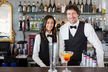 Portrait of waiter and waitress smiling