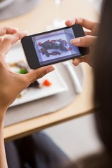 Woman taking photograph of meal