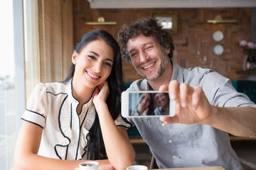 Couple taking a selfie in cafeteria