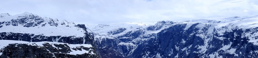 Panorama of snow-capped mountains and huts