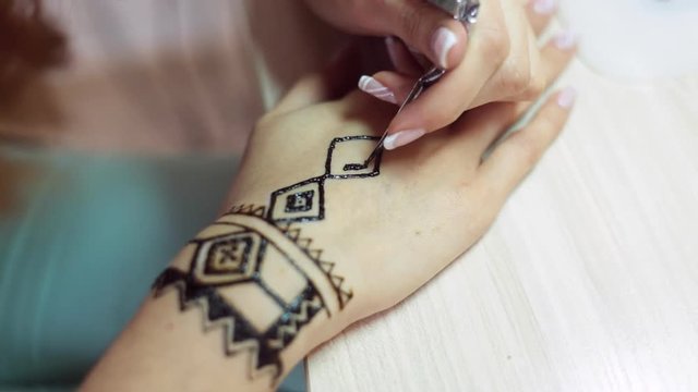 Henna tattoo on women hands