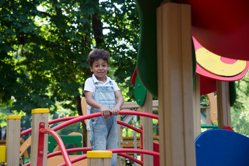 Fototapeta na wymiar afro american school boy plays on playground