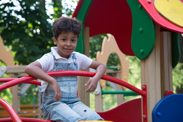 afro american school boy plays on playground