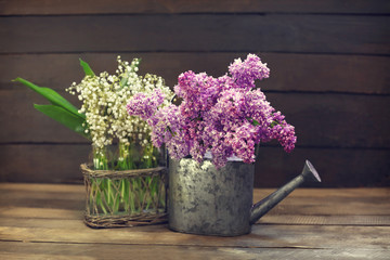 Bouquets of spring flowers on wooden background