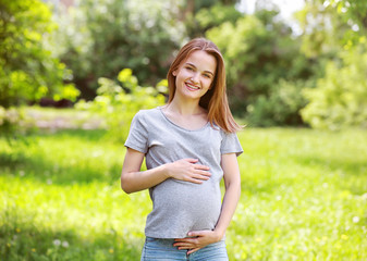 Beautiful pregnant woman in park