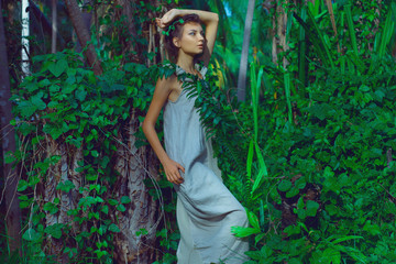 sensual portrait of young beautiful woman with jungle background