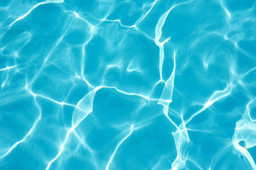 Ripple water surface with sun reflection in swimming pool