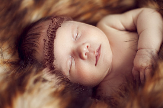 Newborn Baby Sleeping Peacefully On The Red Fur