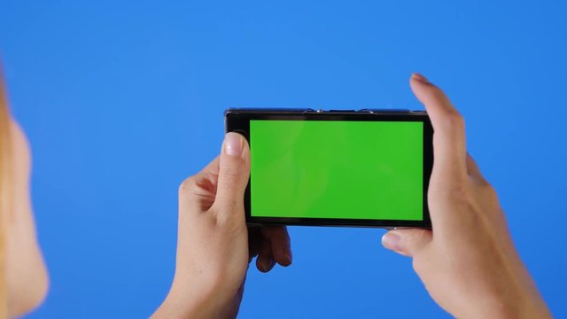Taking photos in front of blue screen 4K 2160p UHD footage - Chroma green screen on phone in front blue screen 4K 3840X2150 UHD video 