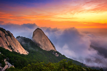 Bukhansan mountains is covered by morning fog and sunrise in Seo