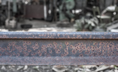 Stack of steel and rusty rail profiles.
