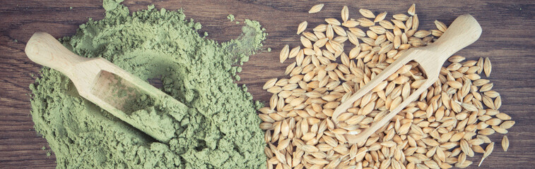 Vintage photo, Heap of young powder barley and barley grain on wooden background, body detox