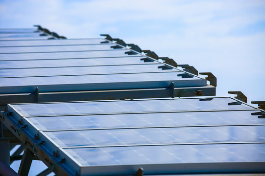 Solar Cell Generated Electrical Power by Sun Light, Closeup of Blue Photovoltaic Solar Panels, Green Energy for Safe World, Power Supply and Generated Electrical Power to Battery, 