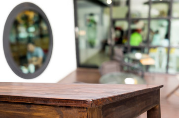 Selected focus empty brown wooden table and Coffee shop blur bac