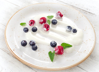 Breakfast of yogurt and fresh berries.