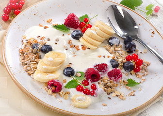 Breakfast of yogurt, fresh fruits and muesli.