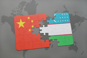 puzzle with the national flag of china and uzbekistan on a world map background.