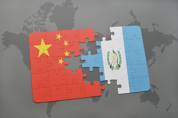 puzzle with the national flag of china and guatemala on a world map background.