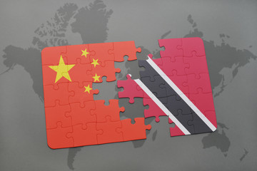 puzzle with the national flag of china and trinidad and tobago on a world map background.