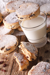 Delicious Welsh cakes with raisins and milk close-up. vertical
