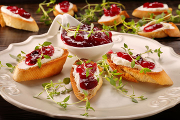 Toast with white cottage cheese cherry jam and fresh herbs