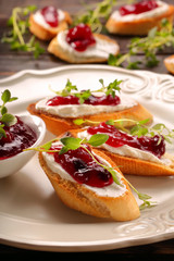 Toast with white cottage cheese cherry jam and fresh herbs
